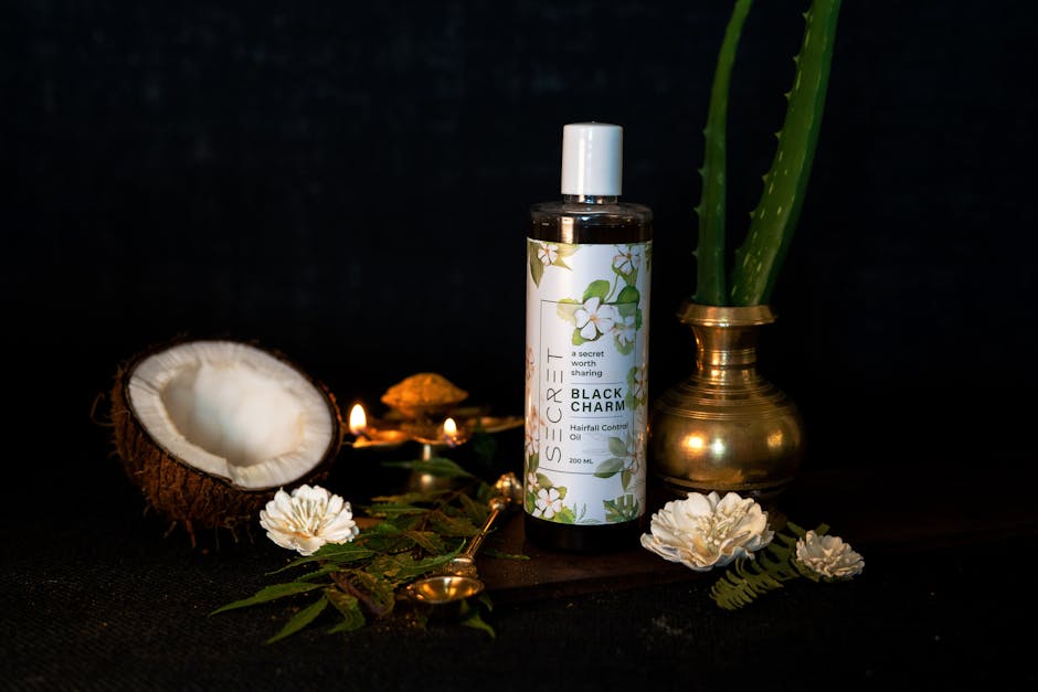 Stylish presentation of herbal hair oil with coconut and aloe on a black background.