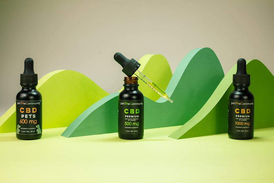 CBD oil bottles with varying dosages in a creative green backdrop, showcasing premium product packaging.