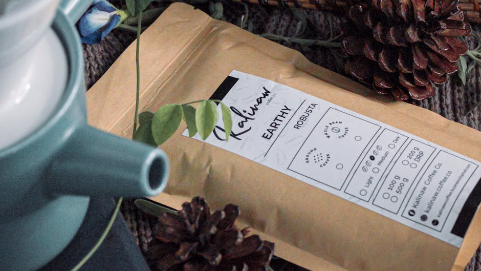 A rustic scene featuring coffee packaging surrounded by pine cones and a teal teapot.