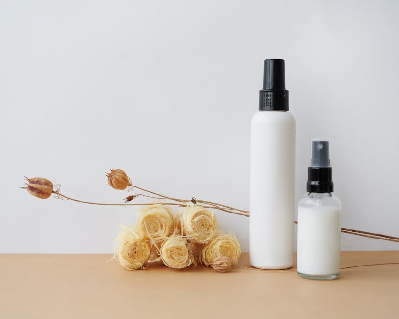 Simple minimalist cosmetic bottle design with natural elements like dried flowers. Ideal for branding.