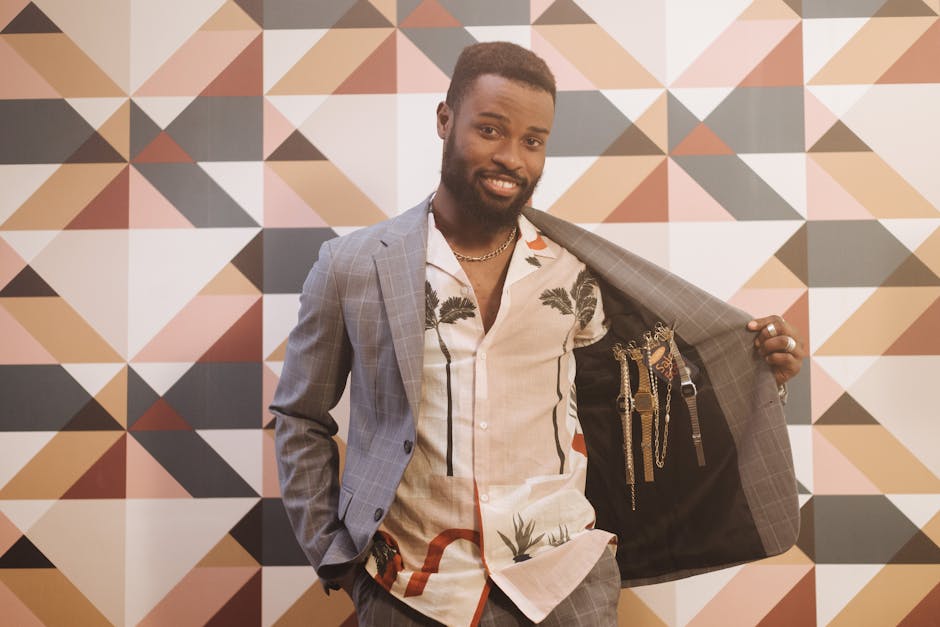 Confident man displaying watches inside his jacket with geometric background.