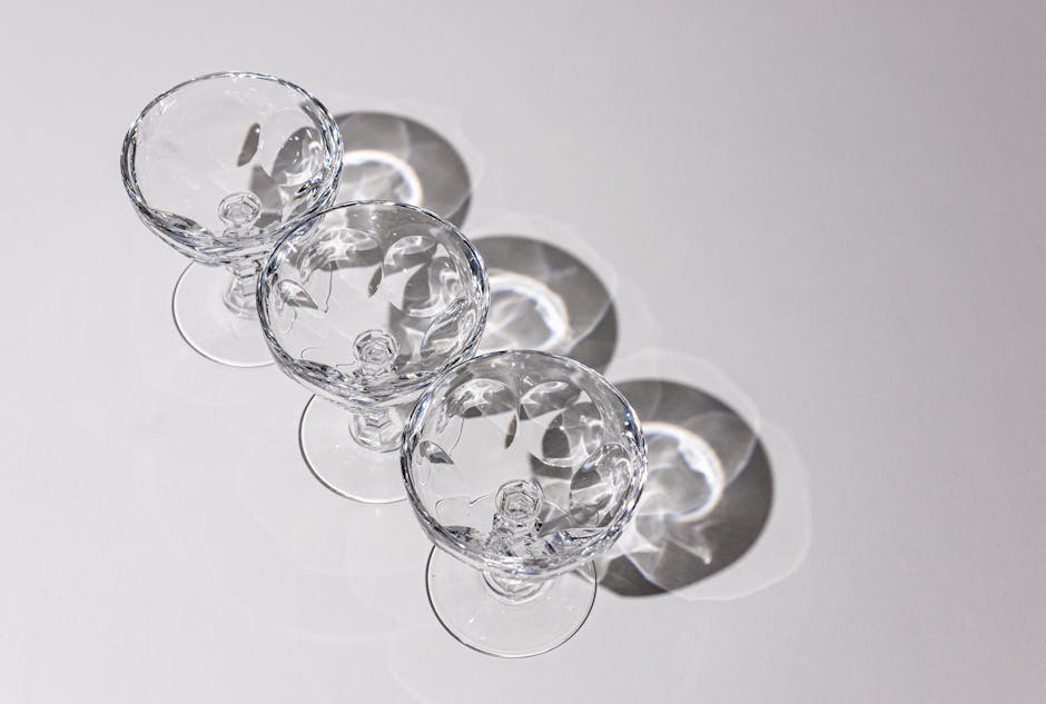 Three crystal glasses casting artistic shadows in bright sunlight.