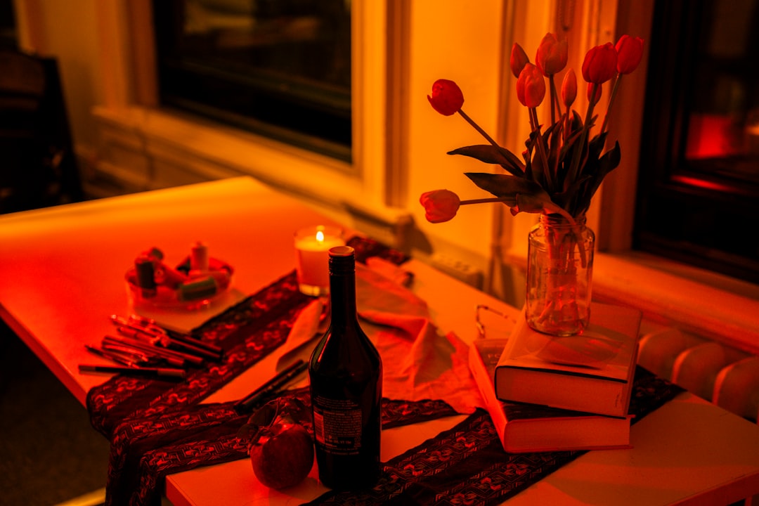 Table setting with wine, flowers, and candle