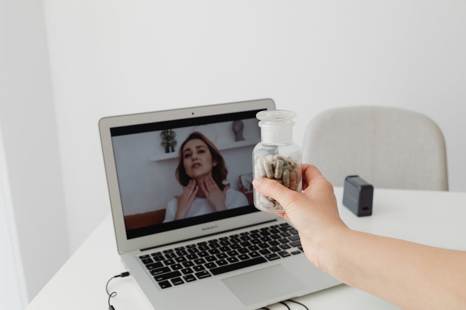 Person holding supplements during a virtual consultation with a doctor on a laptop.