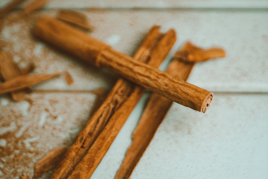 Aromatic cinnamon sticks on a rustic surface, emphasizing natural flavor and aroma.