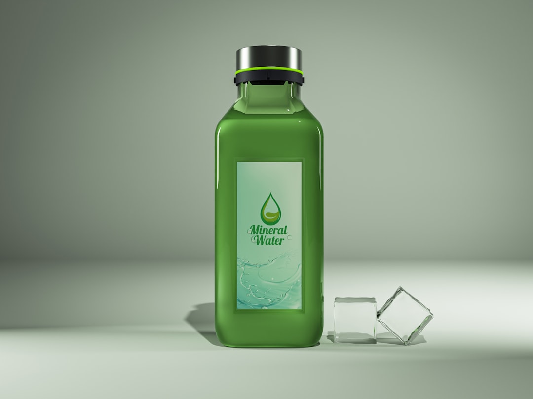 Here is a short caption: a green mineral water bottle and ice cubes.
