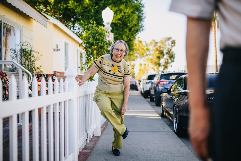 Happy senior woman having fun on a sunny day in a suburban street.
